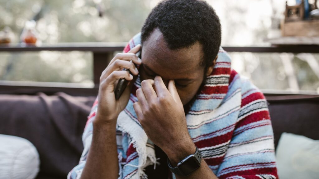 Sad man talking on the phone. RDNE Stock Pexels